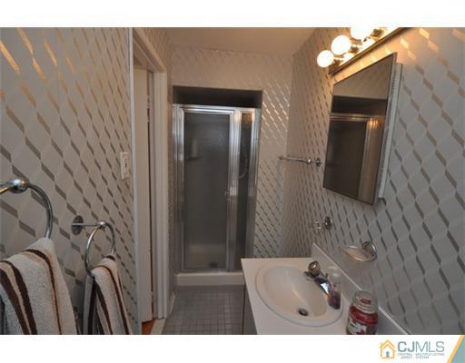 38 Dumas Road Old Bridge, NJ 08857 - Photo 5 of 18 a bathroom with a sink and mirror