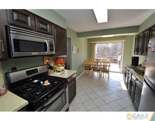38 Dumas Road Old Bridge, NJ 08857 - Photo 7 of 18 a kitchen with stainless steel appliances a stove a sink and a microwave