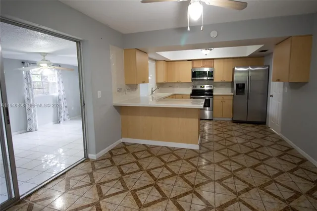 a kitchen with stainless steel appliances a refrigerator and a stove top oven