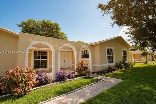 a front view of a house with garden