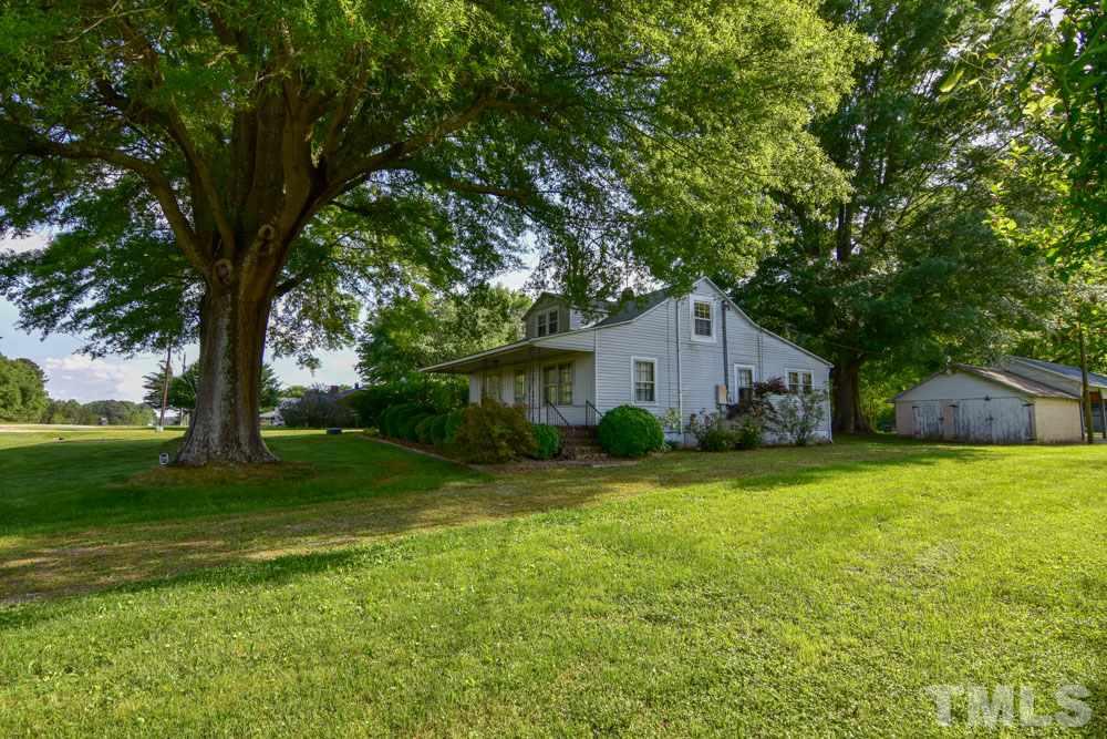 8919 North Roxboro Road Bahama, NC 27503 - Photo 1 of 26 a house view with a garden space