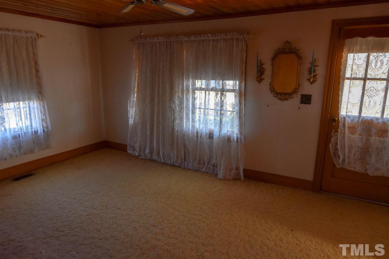 8919 North Roxboro Road Bahama, NC 27503 - Photo 11 of 26 a view of an empty room with windows & cabinet