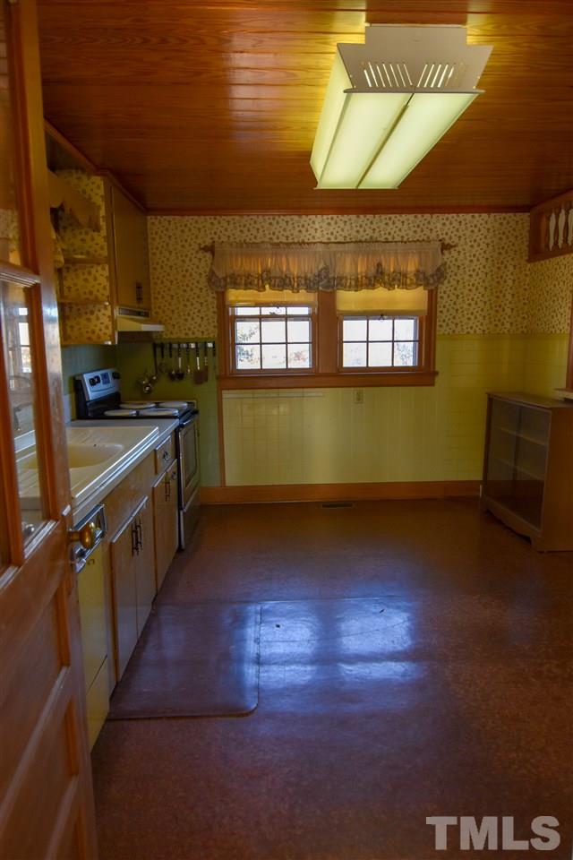 8919 North Roxboro Road Bahama, NC 27503 - Photo 13 of 26 a kitchen with stove and cabinets