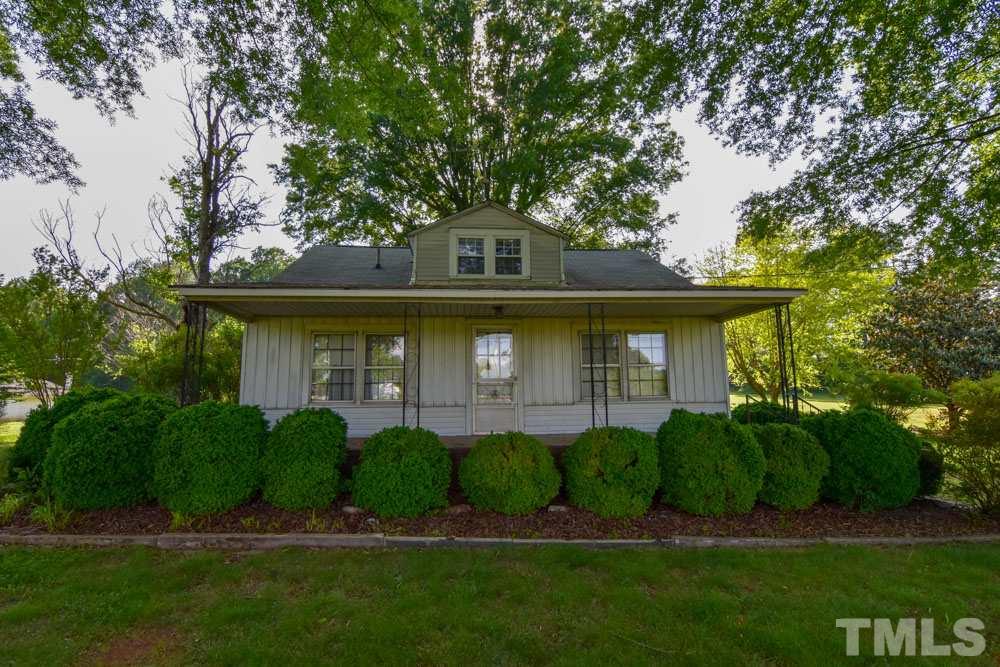 8919 North Roxboro Road Bahama, NC 27503 - Photo 20 of 26 a front view of a house with a garden