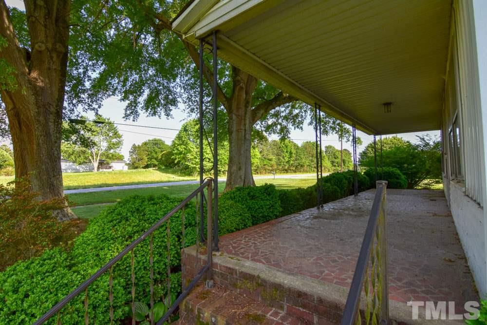 8919 North Roxboro Road Bahama, NC 27503 - Photo 22 of 26 a view of a yard with plants and a fountain