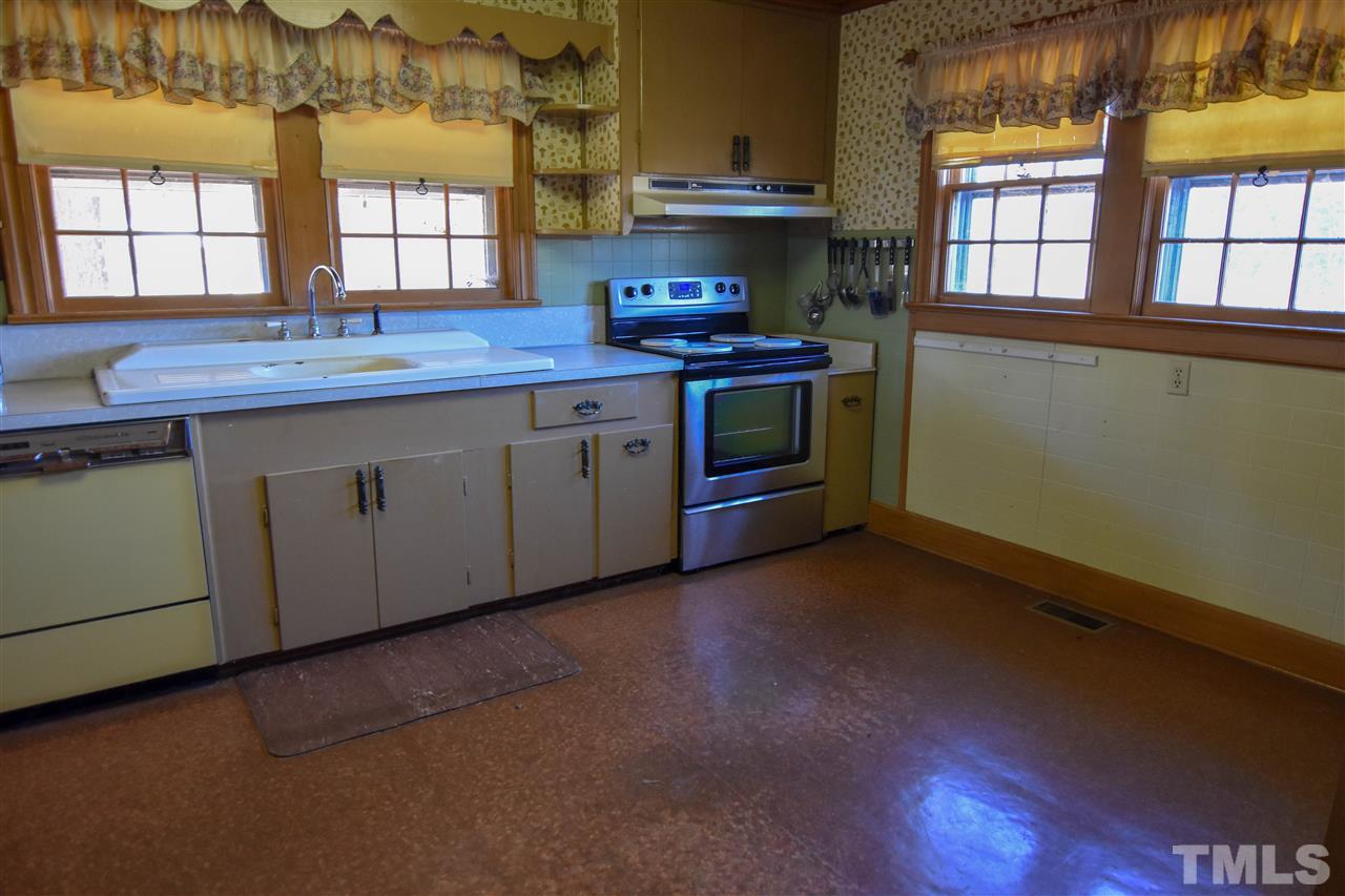 8919 North Roxboro Road Bahama, NC 27503 - Photo 4 of 26 a kitchen with stainless steel appliances granite countertop a sink a stove and a window