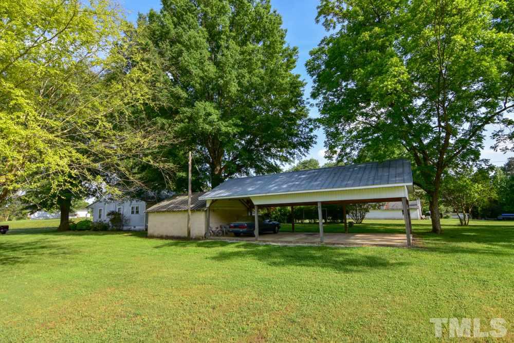 8919 North Roxboro Road Bahama, NC 27503 - Photo 7 of 26 a front view of a house with a yard