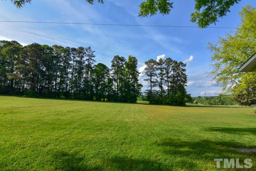 8919 North Roxboro Road Bahama, NC 27503 - Photo 8 of 26 a view of a field with an outdoor space