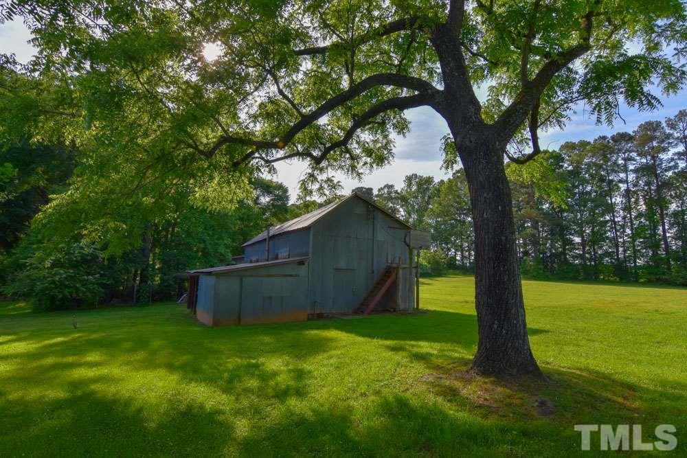 8919 North Roxboro Road Bahama, NC 27503 - Photo 9 of 26 a backyard of a house with lots of green space