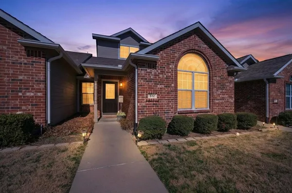 a view of a brick house with large windows