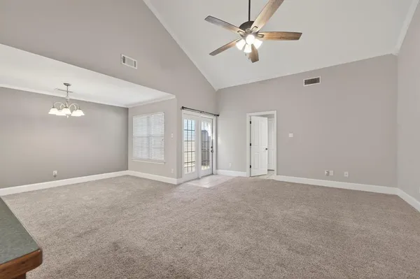 a view of an empty room with a ceiling fan