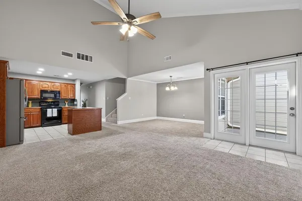 a view of a livingroom with a furniture ceiling fan and window