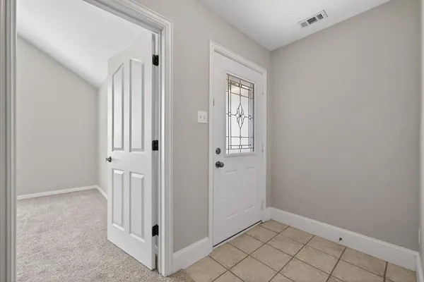 a view of a hallway with wooden floor and entryway
