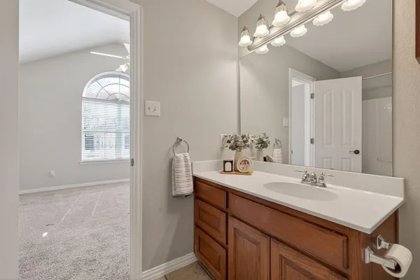 a bathroom with a sink a vanity and a mirror