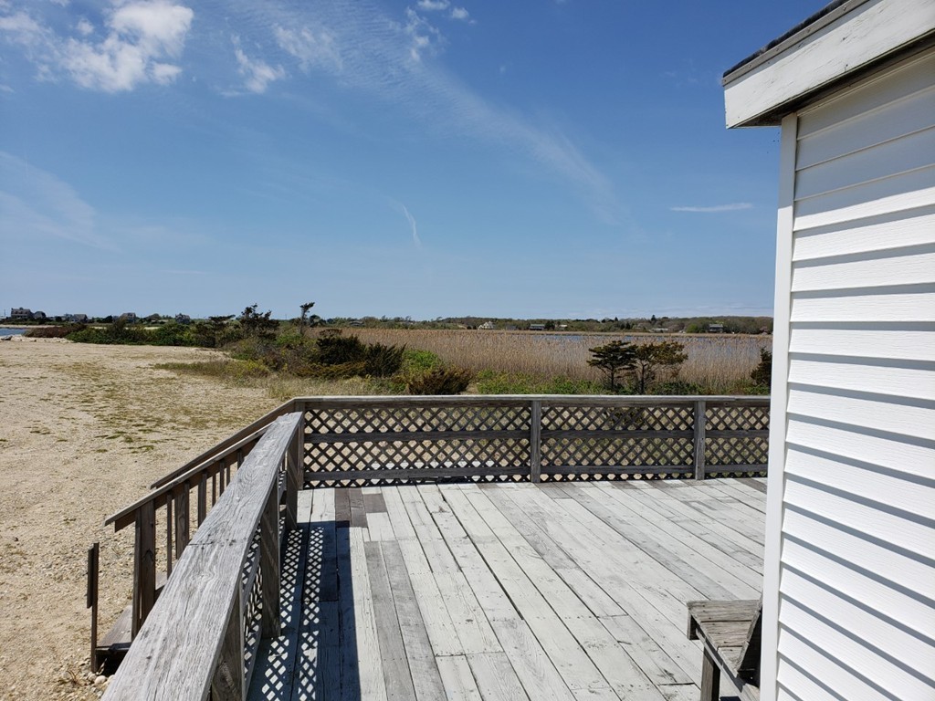 297 Howland Road Westport, MA 02790 - Photo 8 of 11 a view of a roof deck with wooden floor and fence
