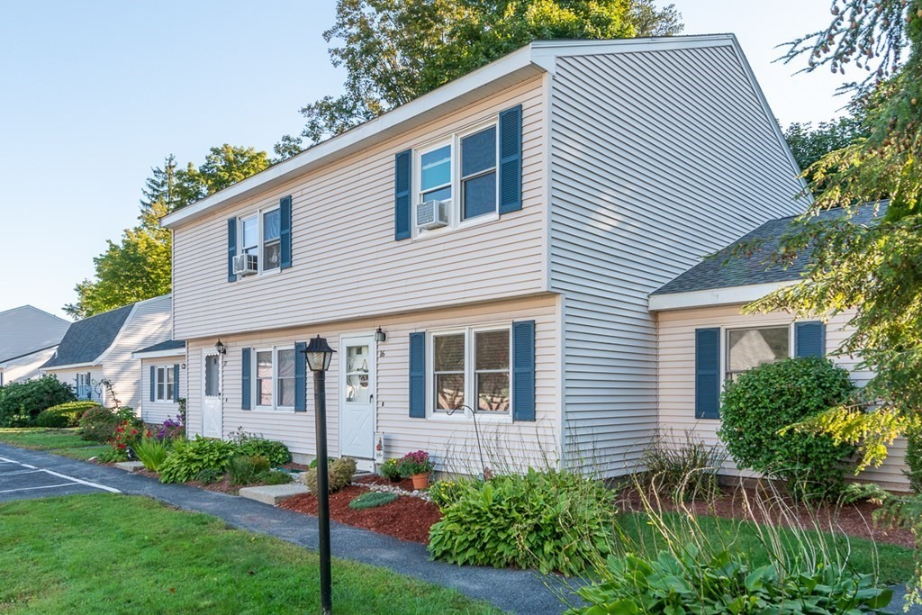 103 Main Street, Unit 16 Pepperell, MA 01463 - Photo 1 of 33 a view of house with a yard and sitting area