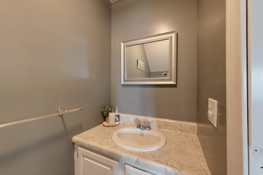 103 Main Street, Unit 16 Pepperell, MA 01463 - Photo 15 of 33 a bathroom with a sink and mirror with toilet