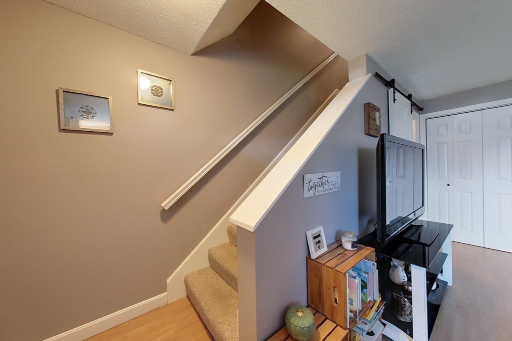 103 Main Street, Unit 16 Pepperell, MA 01463 - Photo 16 of 33 a view of an entryway with furniture and wooden floor