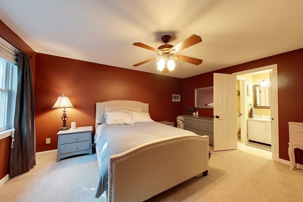 103 Main Street, Unit 16 Pepperell, MA 01463 - Photo 18 of 33 a bedroom with a bed and a chandelier