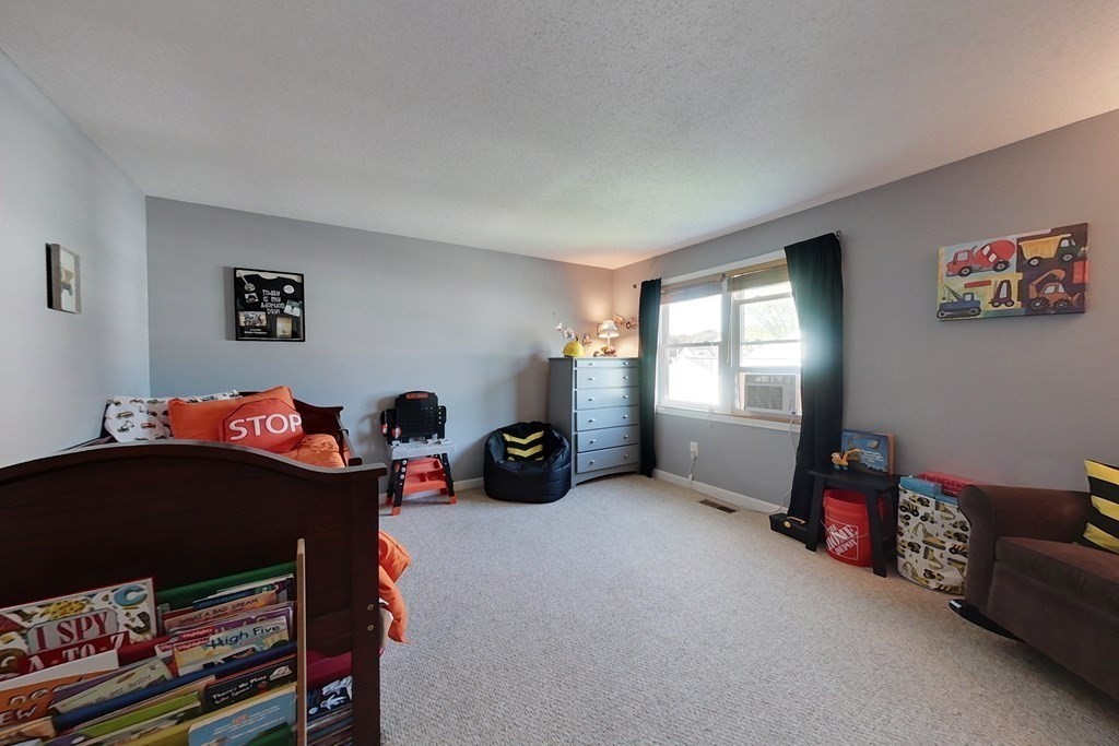 103 Main Street, Unit 16 Pepperell, MA 01463 - Photo 21 of 33 a living room with furniture a flat screen tv and a window