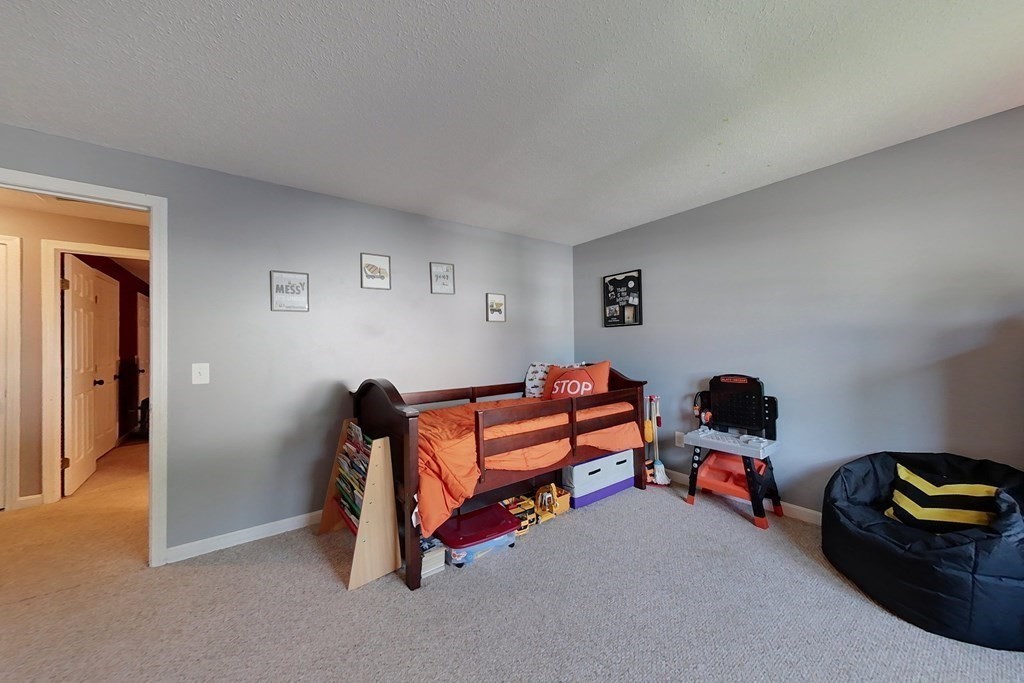 103 Main Street, Unit 16 Pepperell, MA 01463 - Photo 22 of 33 a bedroom with furniture and rug