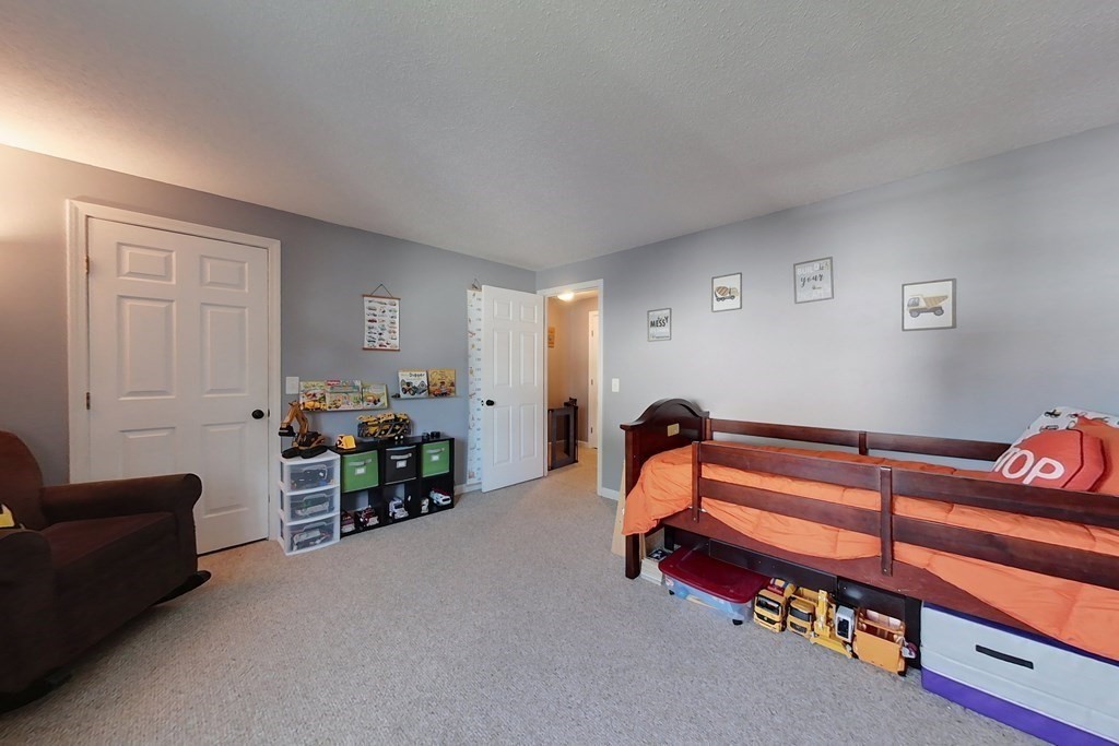 103 Main Street, Unit 16 Pepperell, MA 01463 - Photo 23 of 33 a bedroom with furniture and a window
