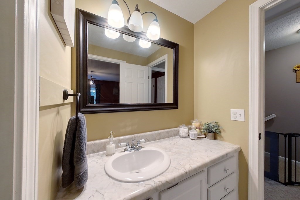 103 Main Street, Unit 16 Pepperell, MA 01463 - Photo 25 of 33 a bathroom with a sink and a mirror