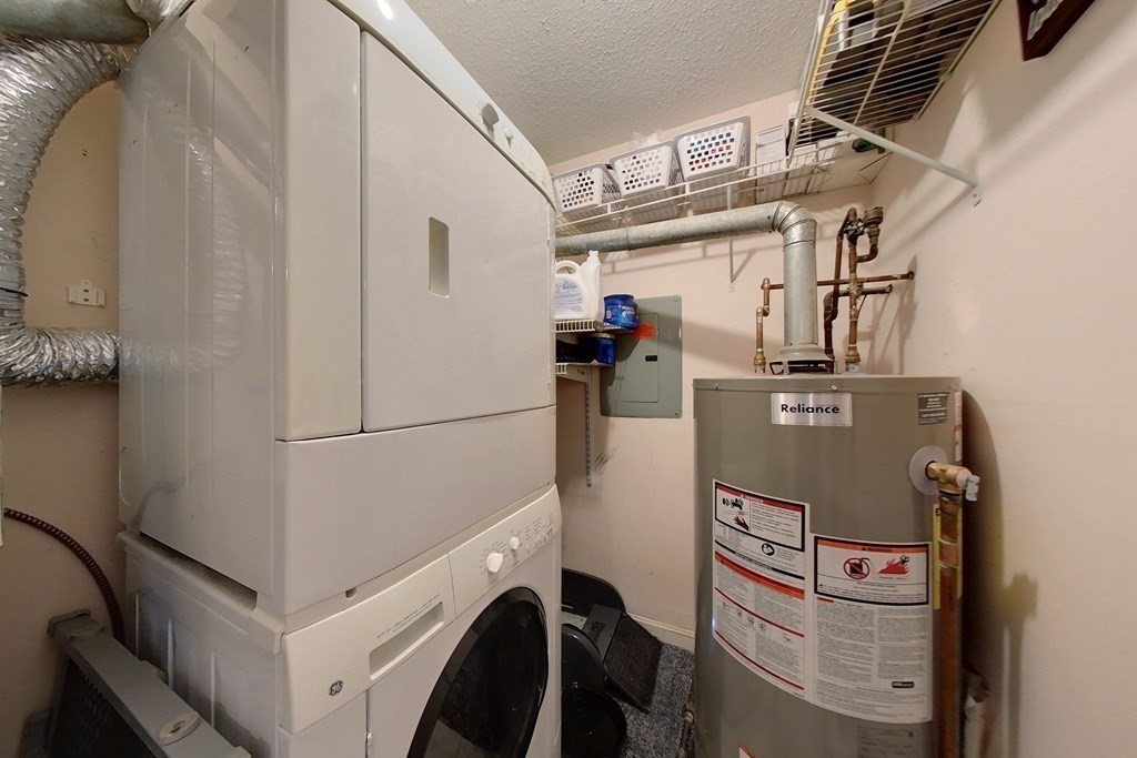 103 Main Street, Unit 16 Pepperell, MA 01463 - Photo 26 of 33 a view of storage and utility room with washer and dryer