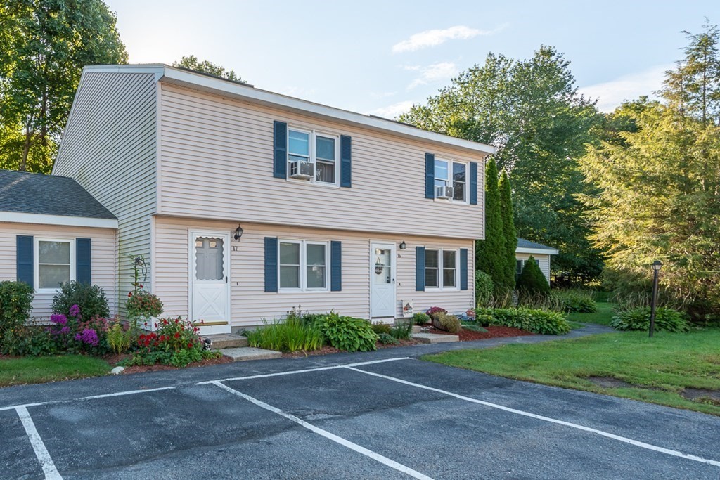 103 Main Street, Unit 16 Pepperell, MA 01463 - Photo 27 of 33 a front view of house with yard and green space