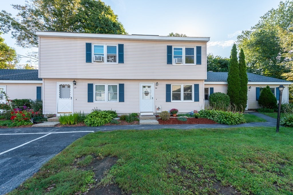 103 Main Street, Unit 16 Pepperell, MA 01463 - Photo 28 of 33 front view of a house with a yard