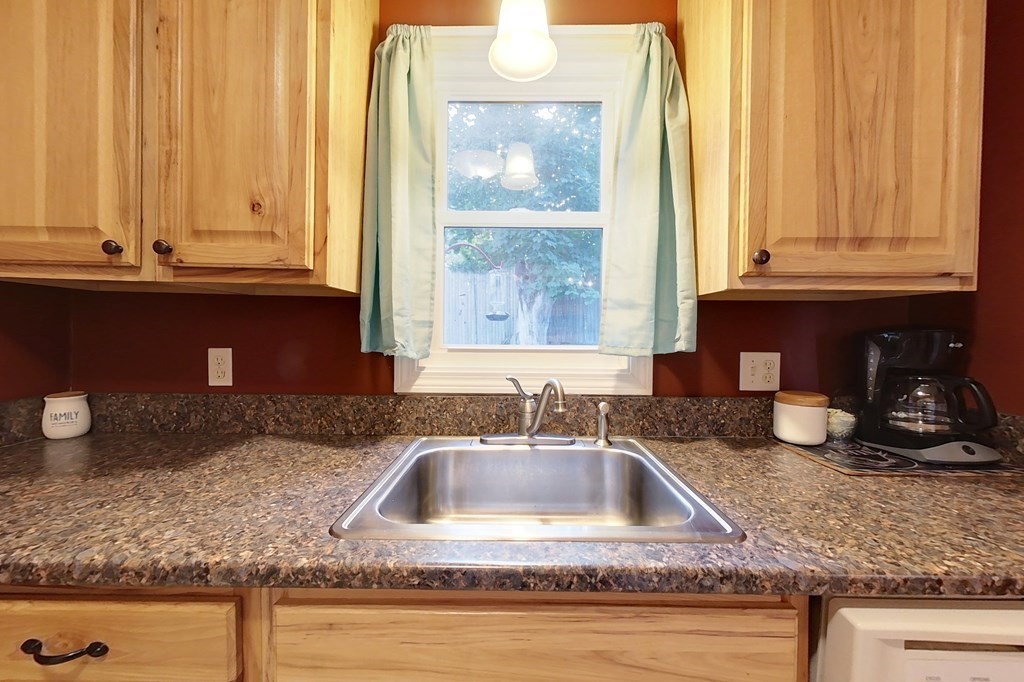 103 Main Street, Unit 16 Pepperell, MA 01463 - Photo 3 of 33 a kitchen with granite countertop a sink and a window