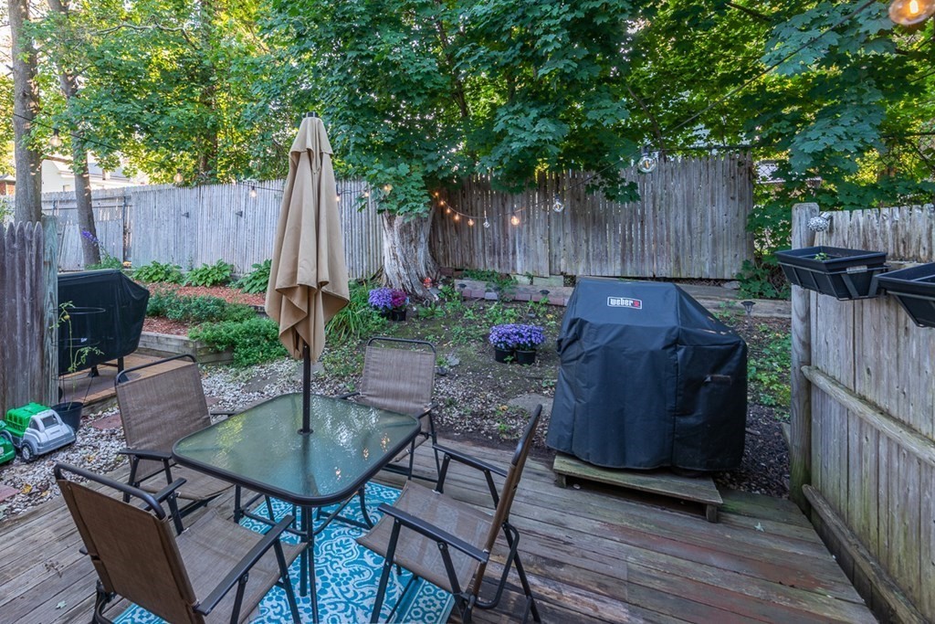 103 Main Street, Unit 16 Pepperell, MA 01463 - Photo 31 of 33 a backyard of a house with table and chairs
