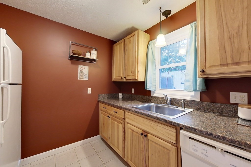 103 Main Street, Unit 16 Pepperell, MA 01463 - Photo 7 of 33 a kitchen with a sink and a window