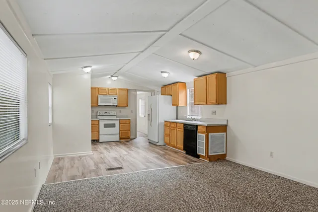 a view of a kitchen with a sink and a stove