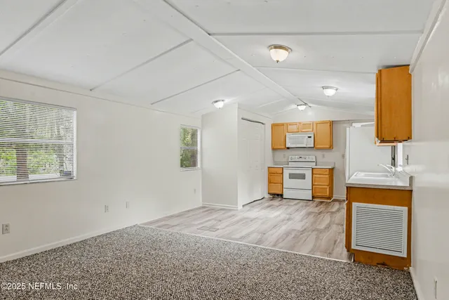 a view of a kitchen with a sink and a window