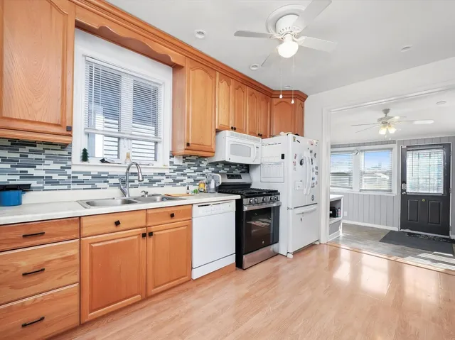 a kitchen with cabinets appliances and a sink