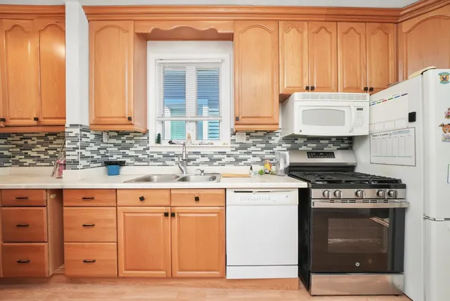 a kitchen with stainless steel appliances granite countertop a stove and a sink