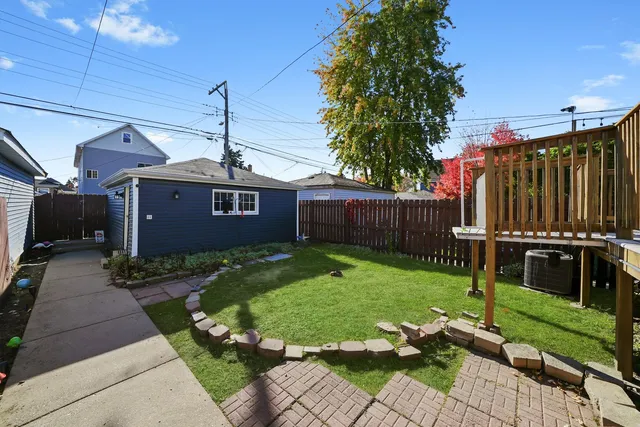 a front view of a house with a garden and deck