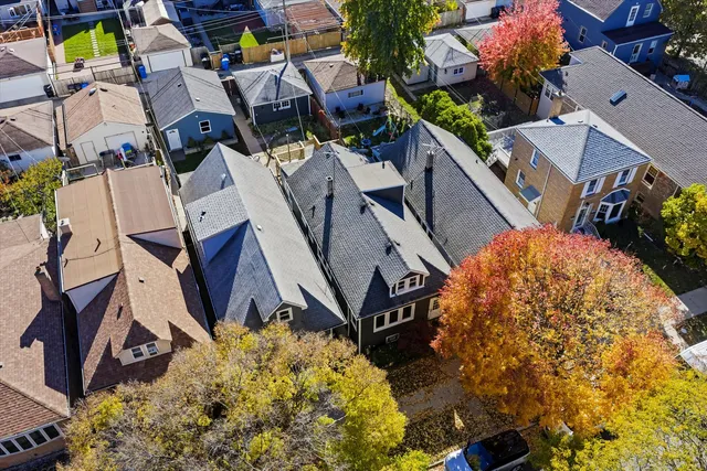 an aerial view of a house with a yard and potted plants