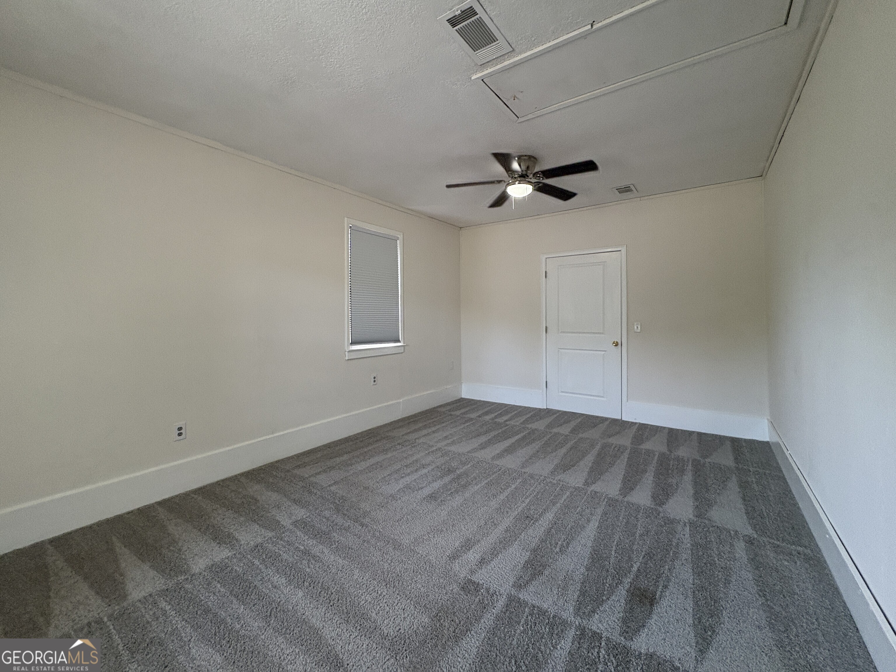 206 Palmetto Street St. Marys, GA 31558 - Photo 13 of 25 an empty room with a ceiling fan and wooden floor