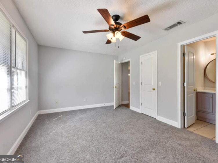 206 Palmetto Street St. Marys, GA 31558 - Photo 18 of 25 an empty room with windows and fan