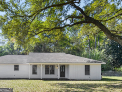 206 Palmetto Street St. Marys, GA 31558 - Photo 2 of 25 a aerial view of a house next to a yard with plants and large trees