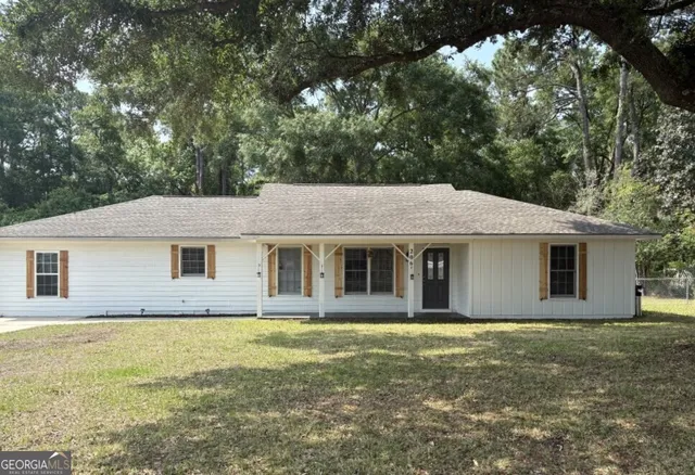 a house that has a tree in front of it