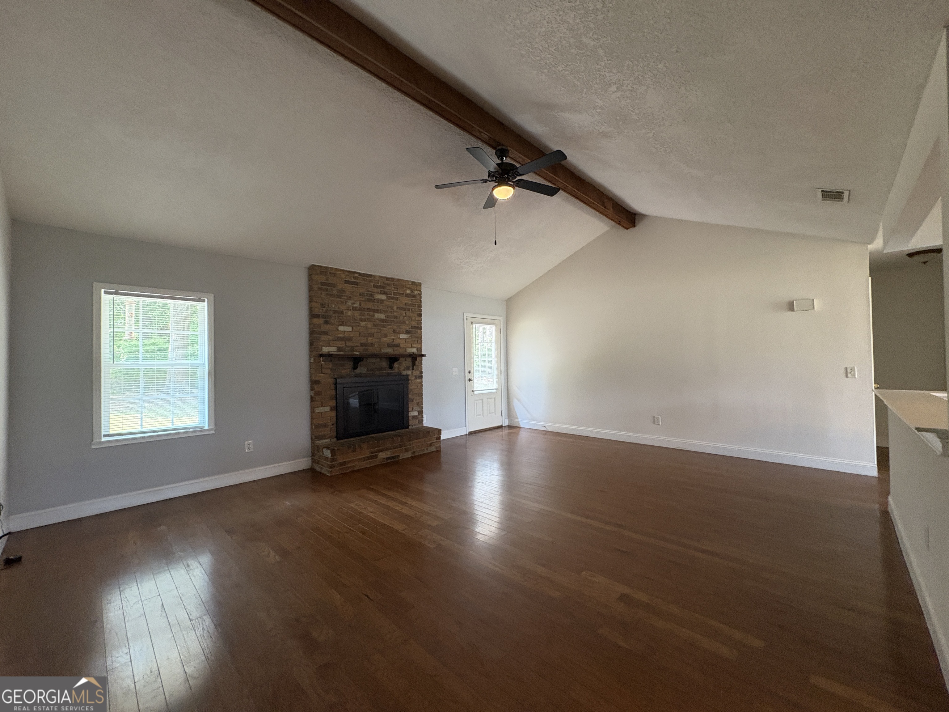 206 Palmetto Street St. Marys, GA 31558 - Photo 6 of 25 an empty room with wooden floor and windows
