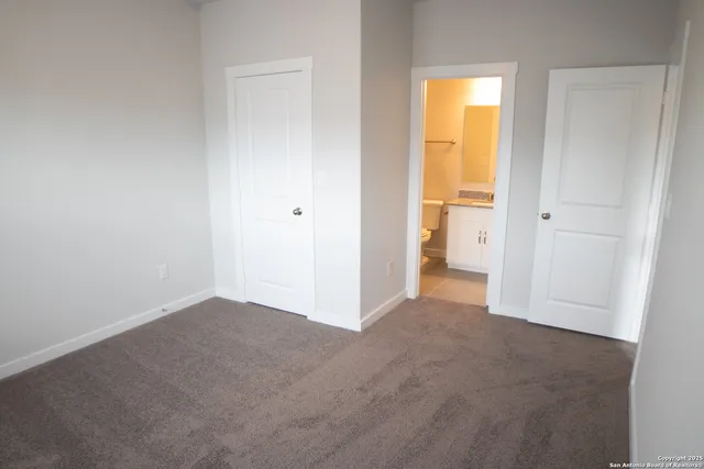 a view of an empty room and a window