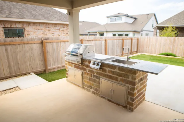 a view of a backyard with table and chairs
