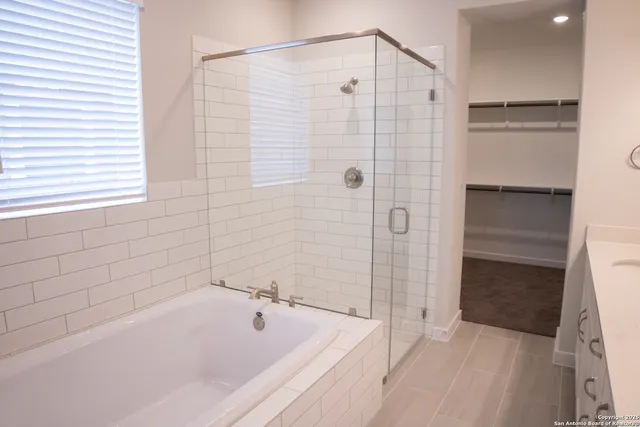 a bathroom with a bathtub and a shower