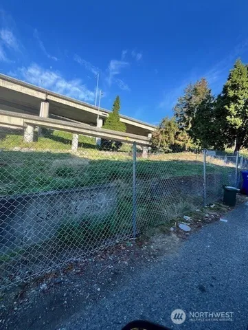 a view of a backyard with plants and a small yard