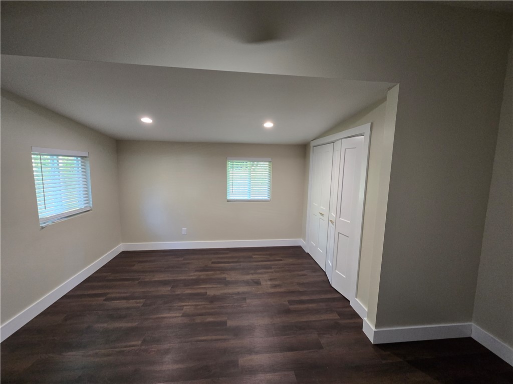 28 Ames Street Seneca, SC 29678 - Photo 5 of 22 Rich wood-look flooring and recessed lighting define this versatile room with built-in closet storage.