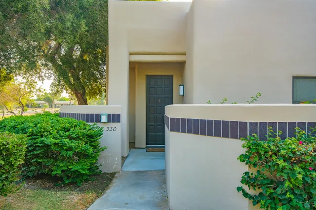 a view of a house with a deck and a garden